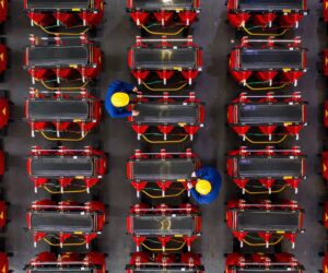 This photo taken on January 4, 2021 shows employees working on a dry-type transformer production line at an electrical production factory in Haian, in eastern China's Jiangsu province. (Photo by STR / AFP) / China OUT