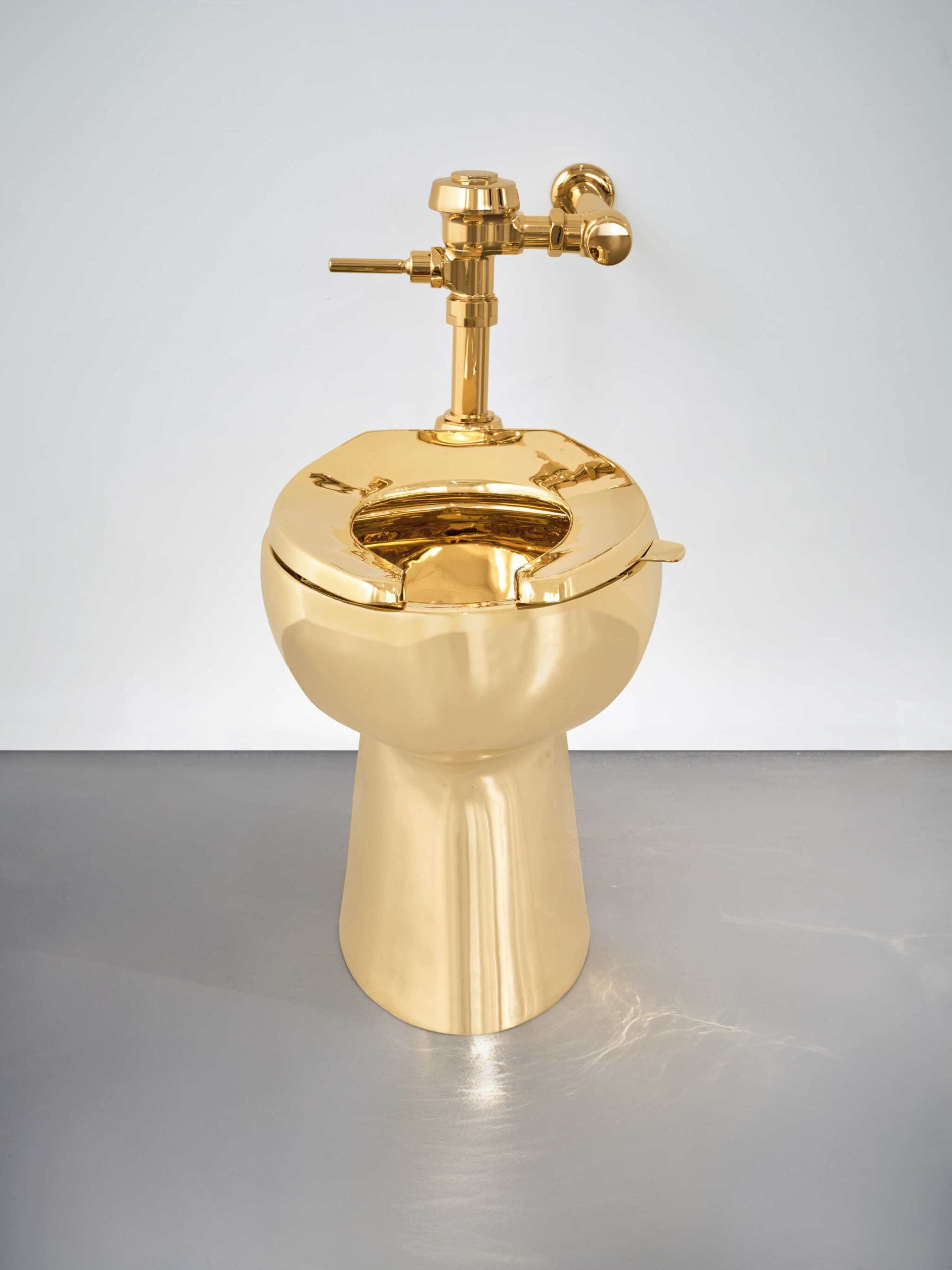 Solid Gold Toilet by Maurizio Cattelan